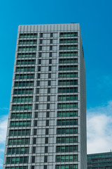 Fototapeta na wymiar modern office skyscraper with clouds in the background