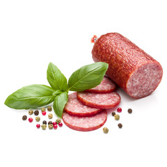 Salami smoked sausage, basil leaves and peppercorns isolated on
