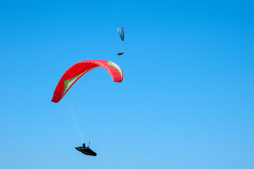 Paraglider flying in the sky on a paraglider. Paragliding.