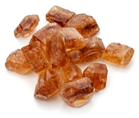 Brown caramelized lump cane sugar cube isolated on white backgro