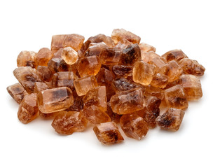 Brown caramelized lump cane sugar cube isolated on white backgro