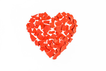 Valentine heart of torn pieces of red paper on white background