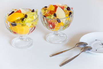 Colored dessert / sweet fruits and jelly in the bowl..