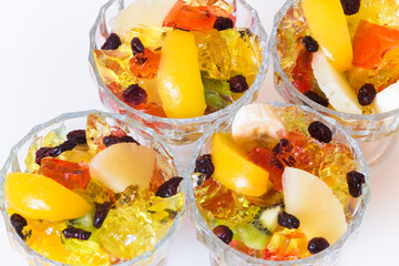 Colored dessert / sweet fruits and jelly in the bowl.