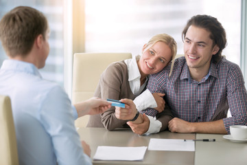 Young happy couple getting a loan concept, first time home buyers, tenancy agreement, agency as a...
