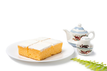 Coconut milk cake with chinese style tea pot on white background