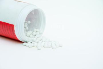 pills with medicine pill bottle close-up on a white background