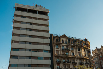 plattenbau building next to historical real estate house