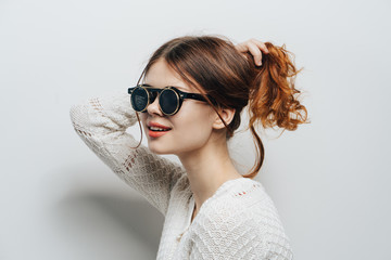 Fototapeta premium stylish lady in gray glasses on a gray background