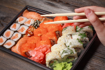 sushi, rolls, in the hands of sticks, Asian cuisine