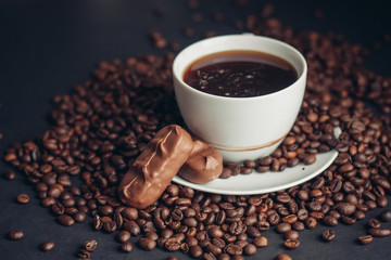a cup of fragrant coffee, grains, a delicious drink, a chocolate bar