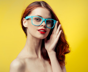beautiful woman, blue glasses, yellow background
