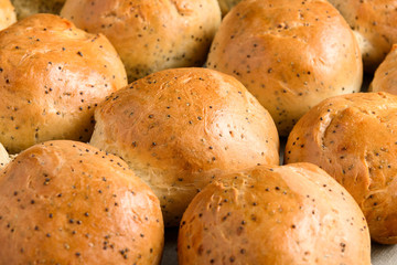 Homemade bread buns with poppy seeds.