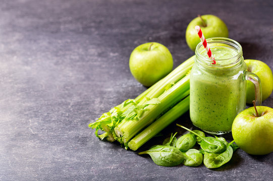 Glass Jar Of Green Juice Smoothie With Spinach, Apple And Celery