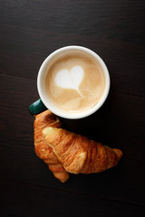 cup coffee and croissant