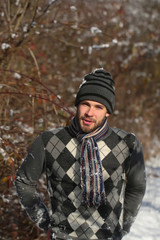 handsome man in winter forest