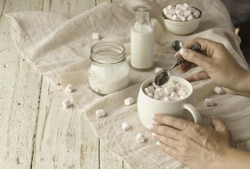 white cup with cocoa and marshmallows, selective focus