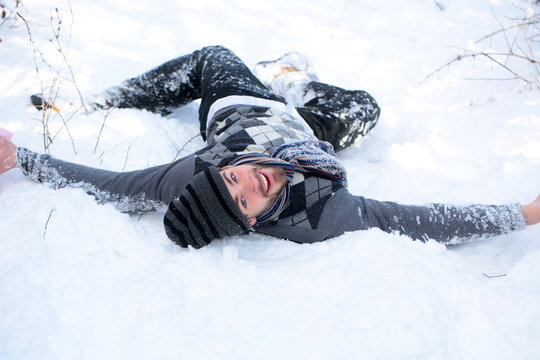 Handsome Man Laying On Snow