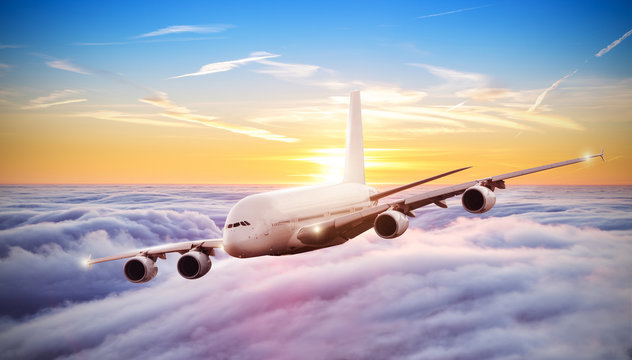 Huge airplane flying above clouds in dramatic sunset