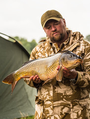 Obraz premium Carp and Fisherman, Carp fishing trophy.