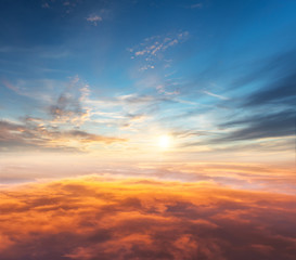Fototapeta na wymiar Beautiful sunset above clouds