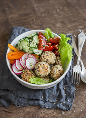Quinoa meatballs and vegetable salad. Buddha bowl on a wooden table. Healthy, diet, vegetarian food concept.