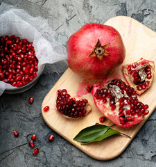 Pomegranate fruits with grains and leaves on the table. Top view. Make juice.