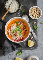 Thai carrot sweet potato soup with rice on the dark table, top view. Flat lay