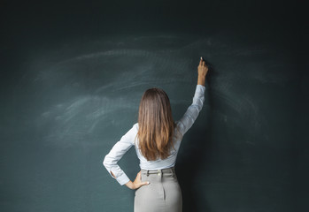 Business woman writing on a board