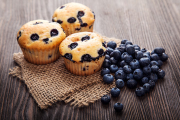 muffin with blueberries on a wooden table. fresh berries and swe