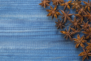 star anise on blue wooden background