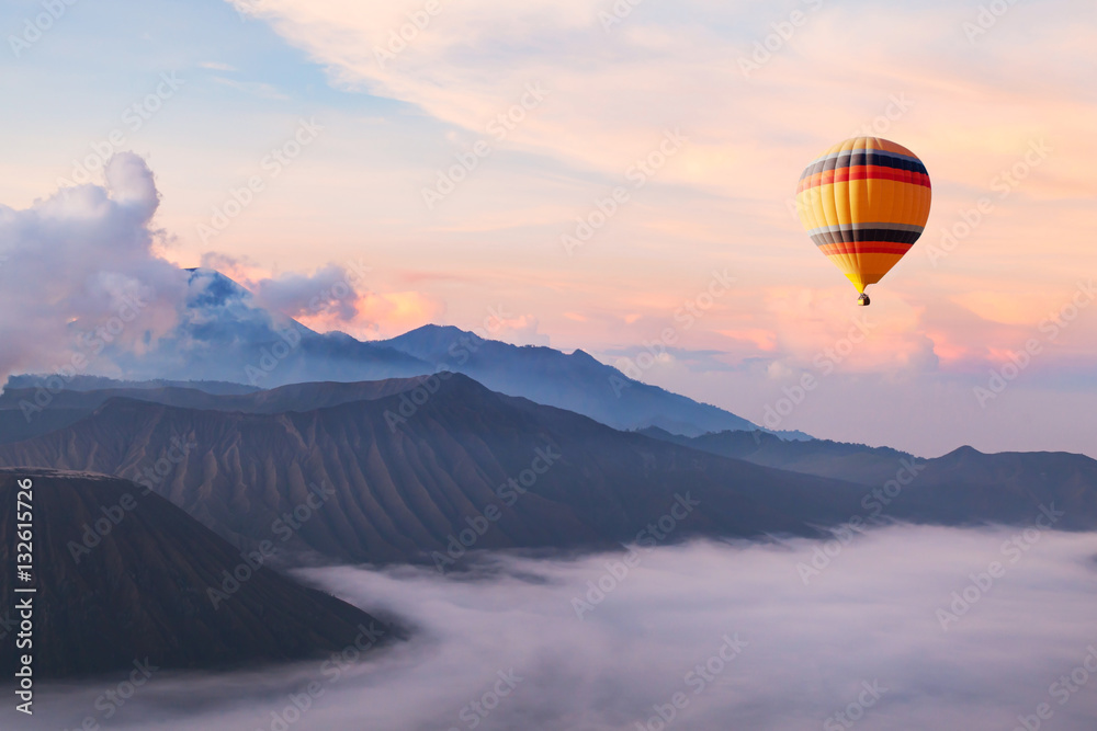 Wall mural beautiful inspirational landscape with hot air balloon flying in the sky, travel destination