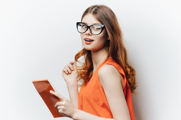 stylish woman with glasses and an orange dress