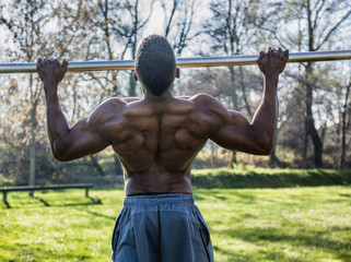 Muscular Shirtless Hunky Black Man Outdoor in City Park. Showing Healthy Muscle Body While Looking...