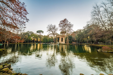 lake with roman building in park