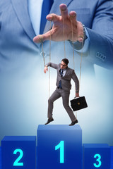 Businessman puppet being manipulated by boss
