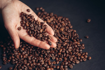 coffee beans, black background, 
coffee beans in hand
