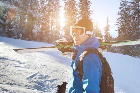 portrait of young happy smiling skier in goggles, active winter holidays