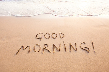good morning, message text concept card, text written on sand beach