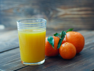 Fresh glass of orange juice on blurred background