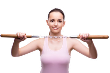 Young woman with nunchucks isolated on white