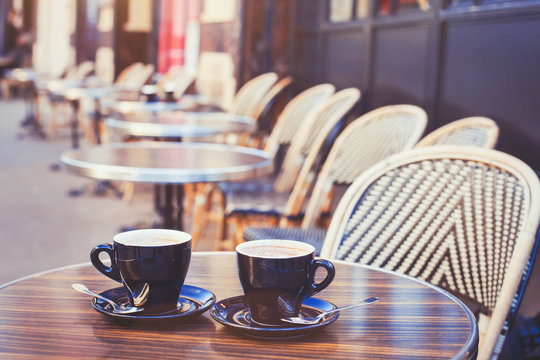 street cafe in Europe, two cups of coffee on cozy vintage terrace