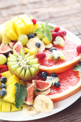 Fresh fruit salad on a grey wooden table