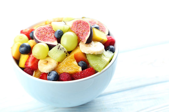 Fresh fruit salad on a white wooden table