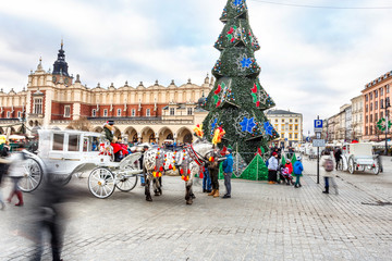 Fair in KRAKOW. Main Market Square and Sukiennice in the evening.