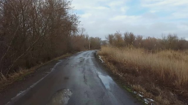 Country road in winter time. Steadicam shot.