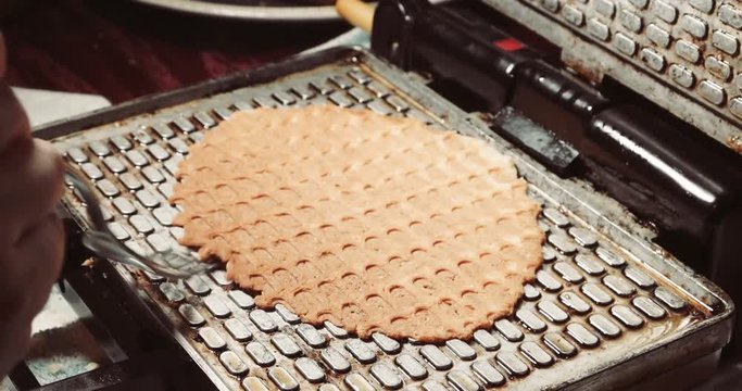 Preparing homemade waffles, frying a dough. Waffle iron in the kitchen