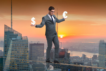 Businessman balancing between choosing dollar and euro
