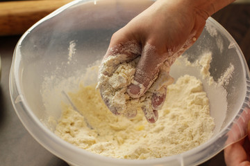 Mixing fresh dough mix with the hands 