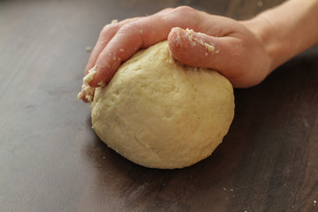 Getting dough ready for rolling on the table